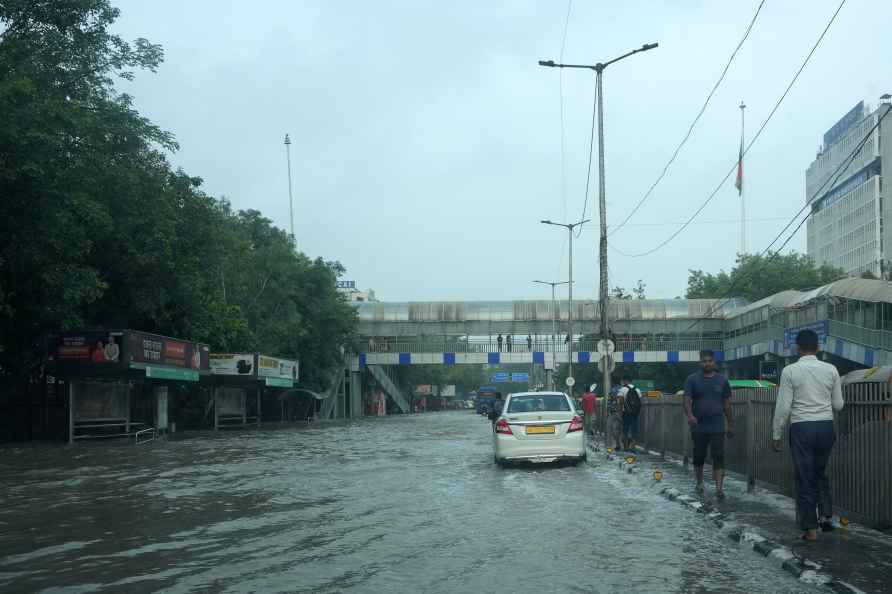 New Delhi: Vehicles pass through a waterlogged road near ITO, in...