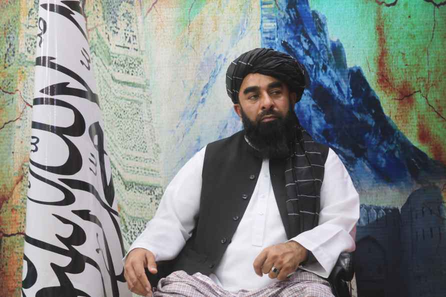 The Taliban's spokesman, Zabihullah Mujahid, sits during an interview...