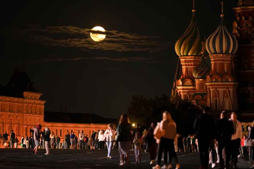 The August Super Blue Moon sets behind a historical building and...