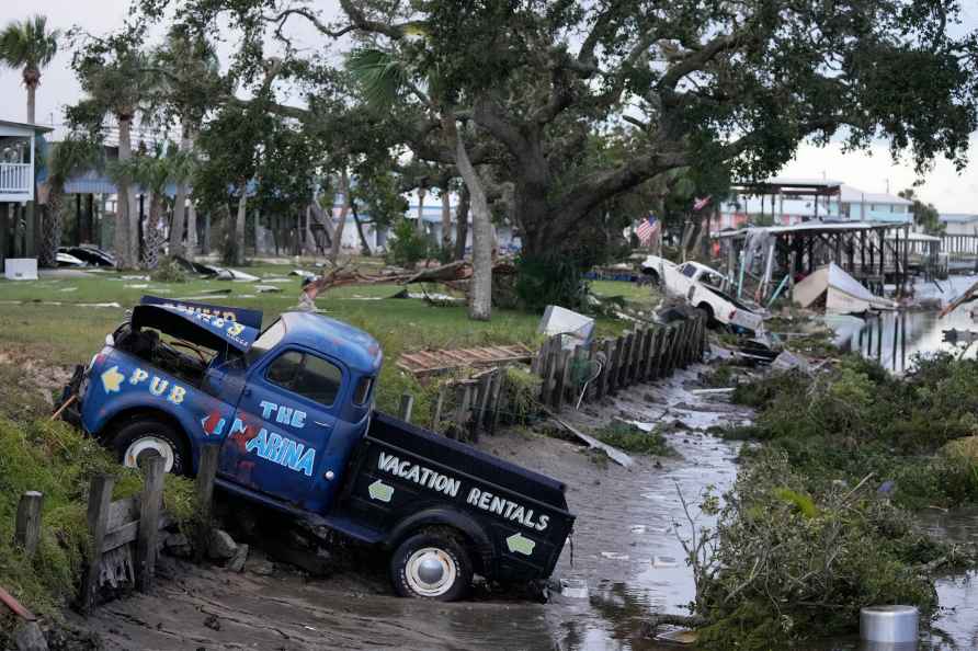 Pick up trucks and debris lie strewn in a canal in Horseshoe Beach...