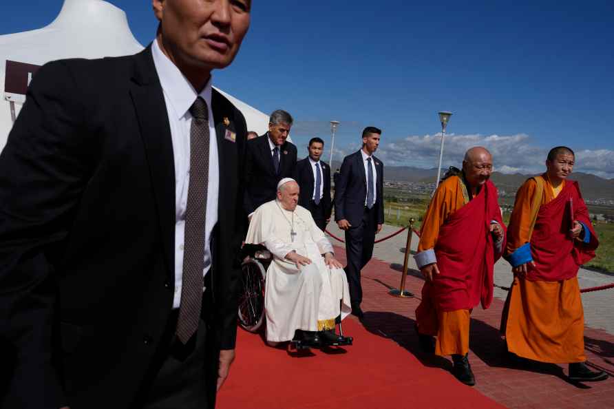 Pope Francis on a wheelchair leaves at the end of a meeting with...