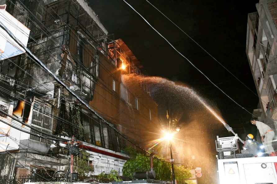 Varanasi: Fire department personnel douse a massive fire which broke...