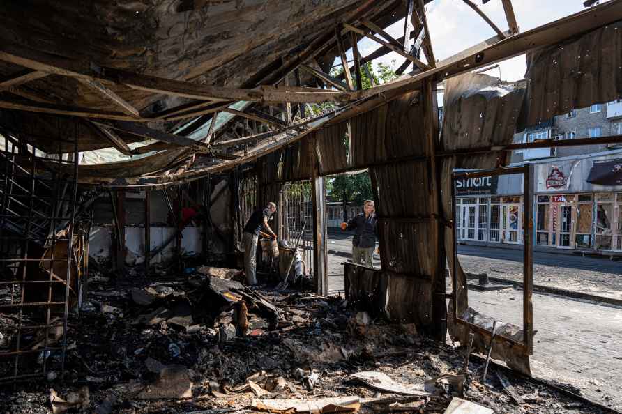 People clear the rubble of a destroyed market