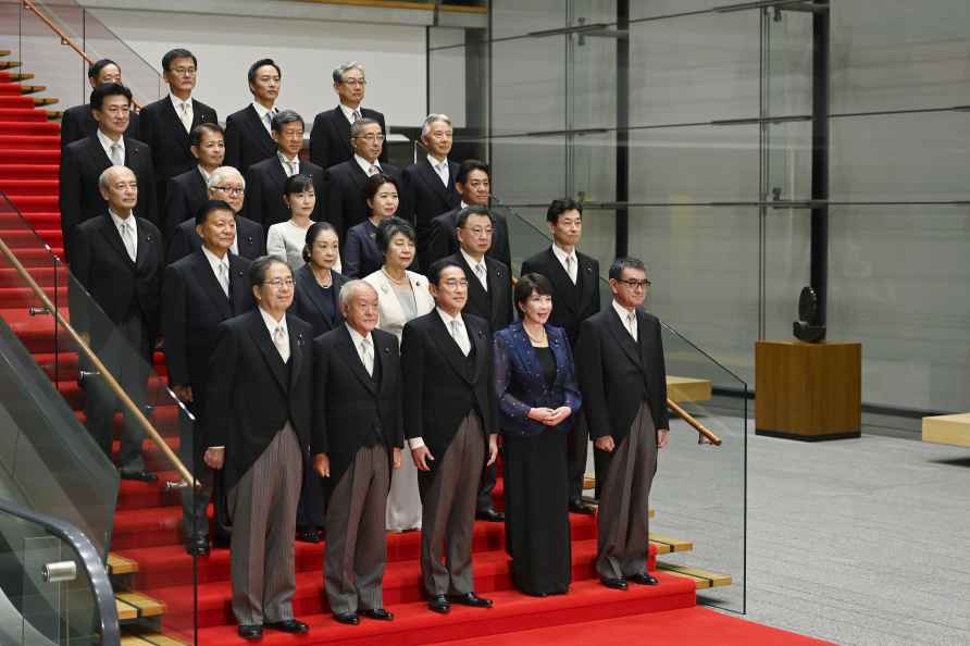 Japanese Prime Minister Fumio Kishida, center, bottom row, poses...