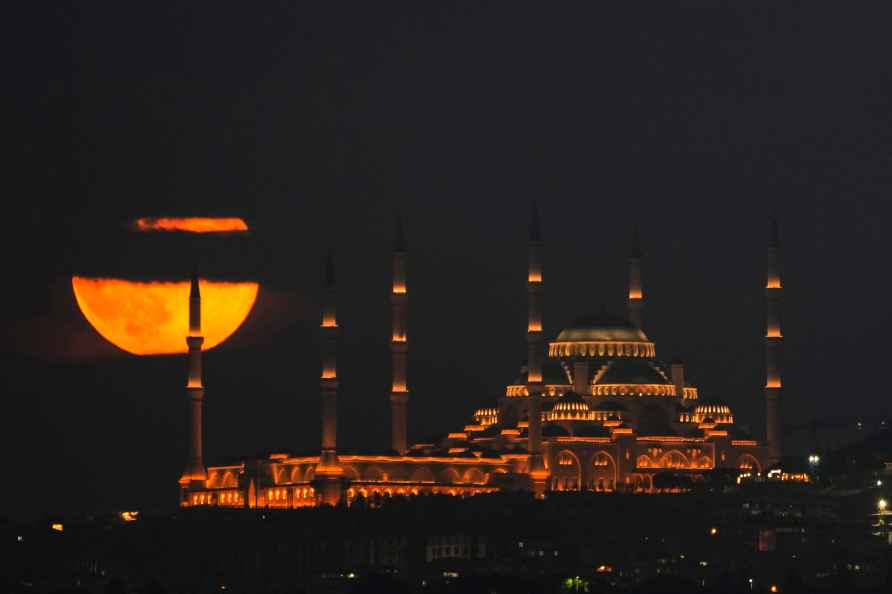 A super moon rises behind Camlica mosque in Istanbul, Turkey, Friday...