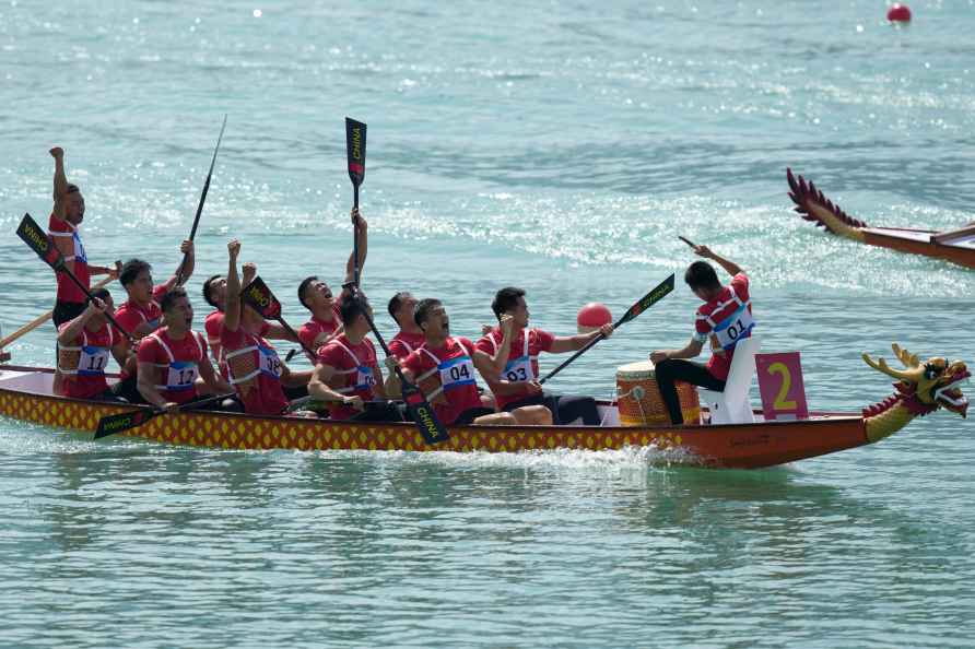 China's dragon boat team celebrate after they win the Men's Dragon...