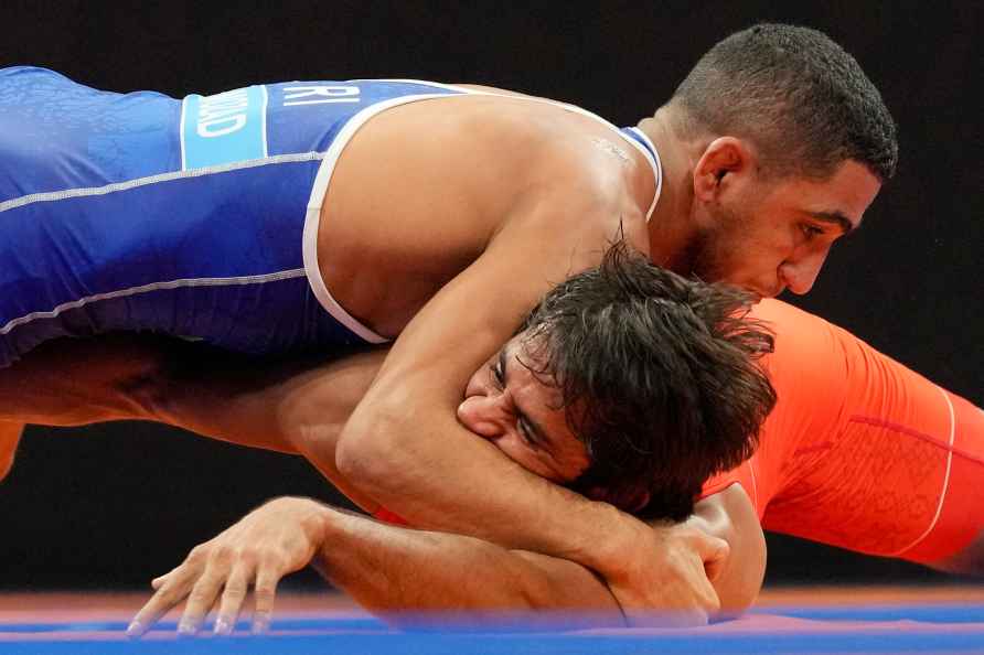 Iran's Rahman Amouzadkhalili, top, and India's Bajrang compete during...