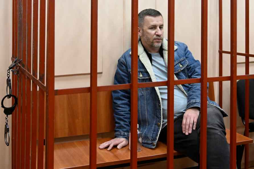 Alexei Navalny's lawyer Igor Sergunin sits in a cage