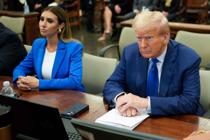 Former President Donald Trump, right, flanked by his defense attorney...