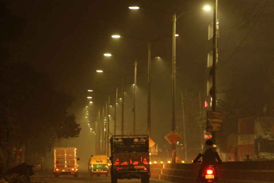 Gurugram: Commuters amid low visibility due to smog, in Gurugram...