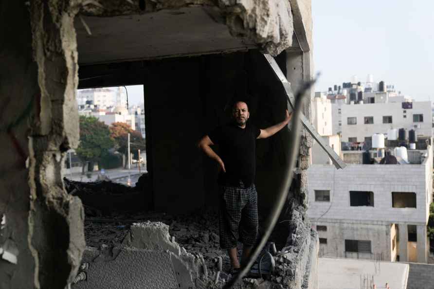 A Palestinian looks at the apartment of Khaled Kharousha that was...