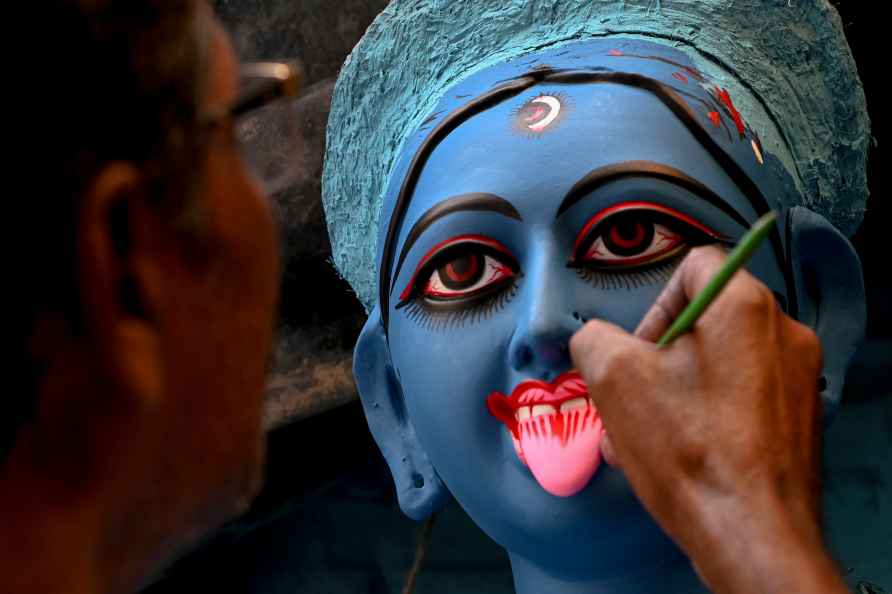 Kolkata: An artist gives final touches to Goddess Kali idol ahead...