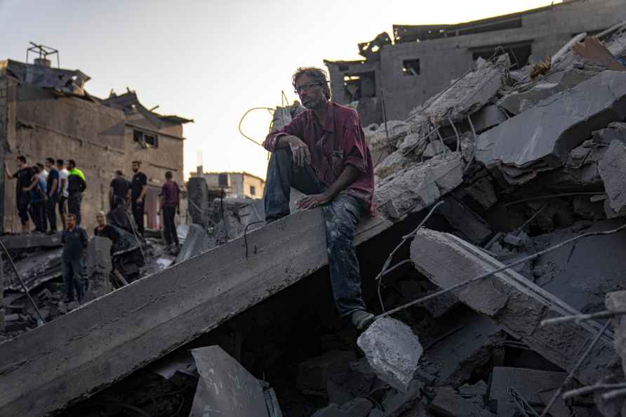 Palestinians look for survivors of the Israeli bombardment of the...