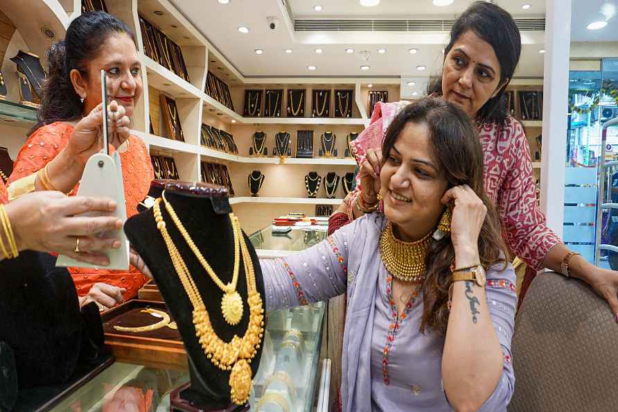 Thane: A customer tries jewellery at a showroom on the occasion ...