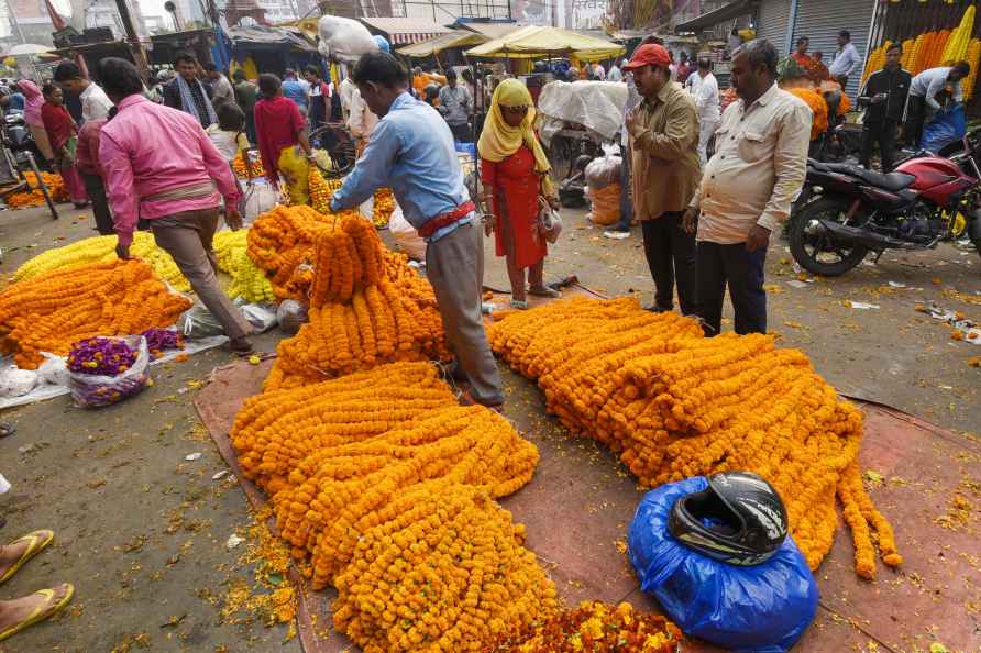 Patna: People purchase garlands at a wholesale flower market ahead...