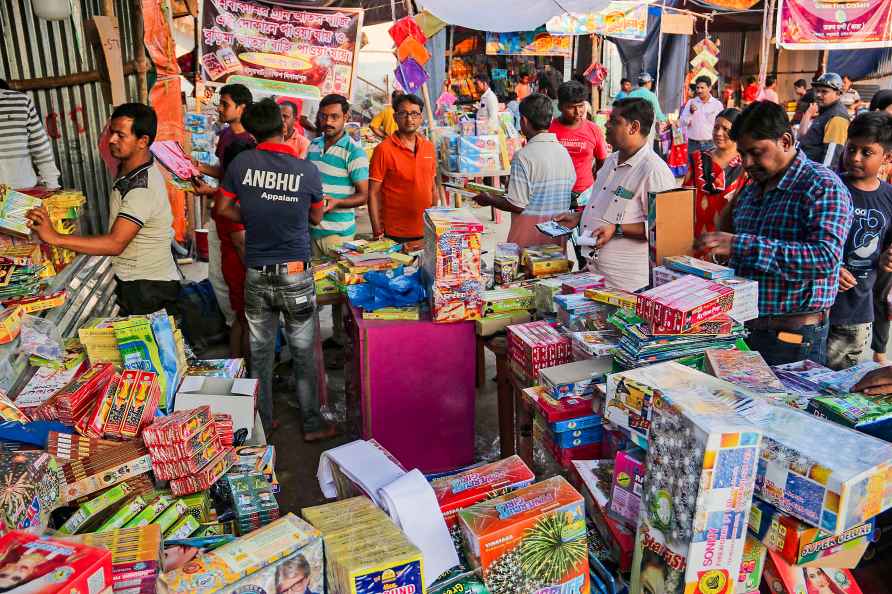 Balurghat: People buy firecrackers at a shop ahead of Diwali festival...