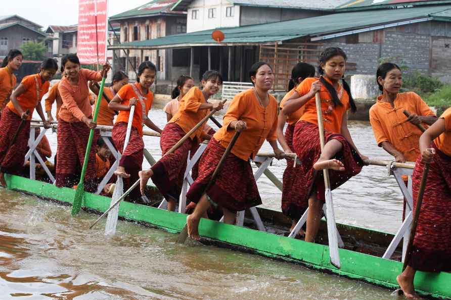 Ethnic Inntha women demonstrate their leg-rowing techniques during...