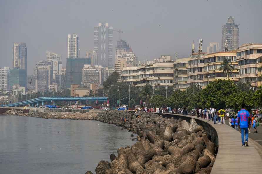 Mumbai: People walk along marine drive as smog envelops the skyline...