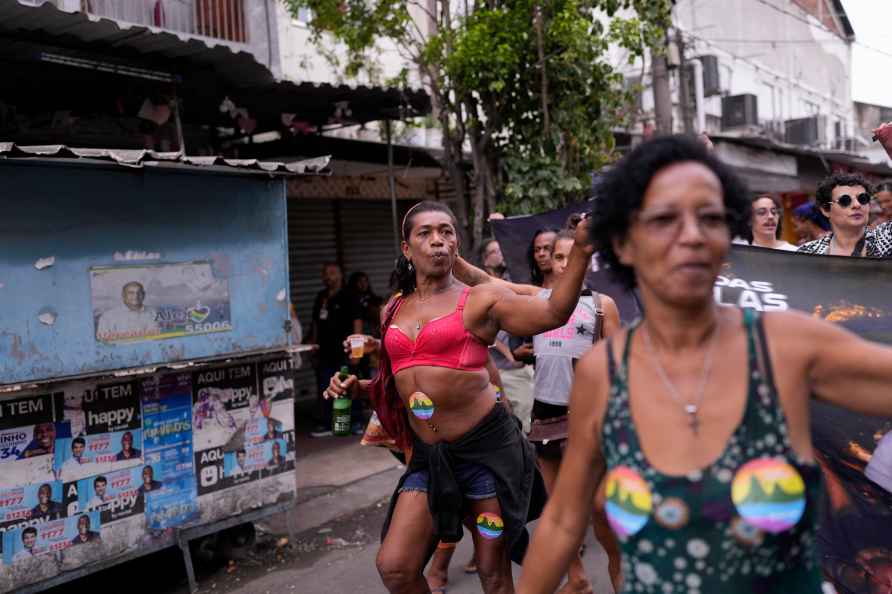 People take part in the Gay Pride Parade at the Mare slum in Rio...