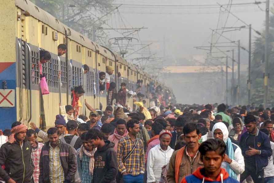 Patna: Devotees arrive by an over-crowded train on Kartik Purnima...