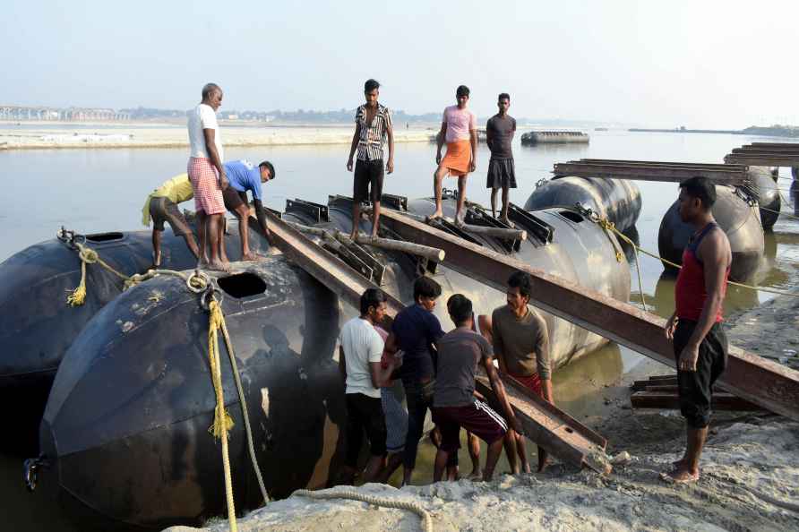 Prayagraj: Labourers build a floating pontoon bridge ahead of the...