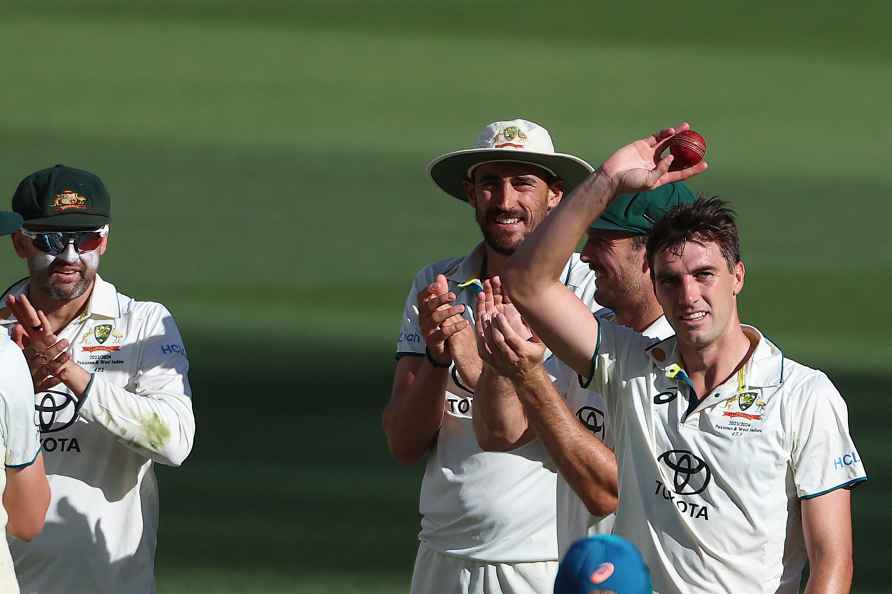 Australia's Pat Cummins, right, hold up the ball after taking 5 ...