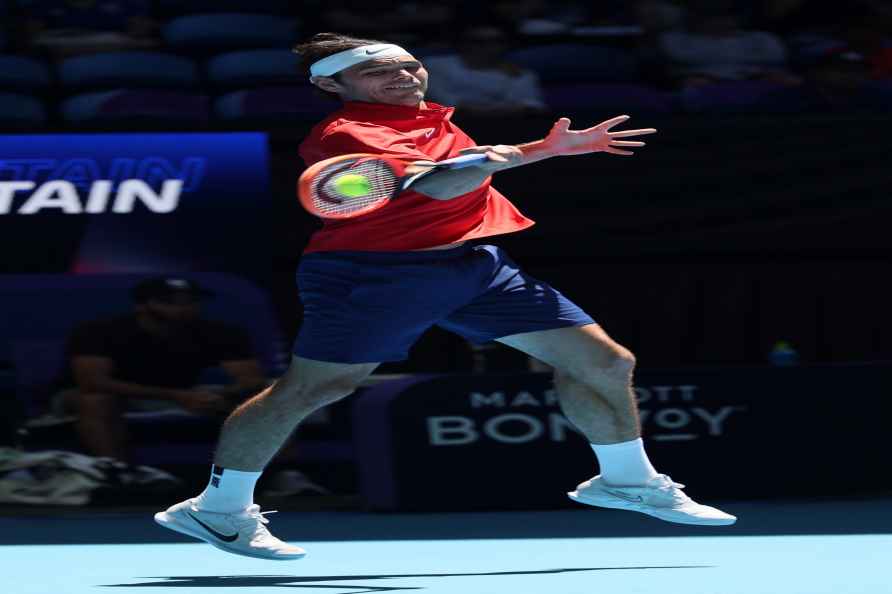 Taylor Fritz of the United States returns a forehand shot to Cameron...