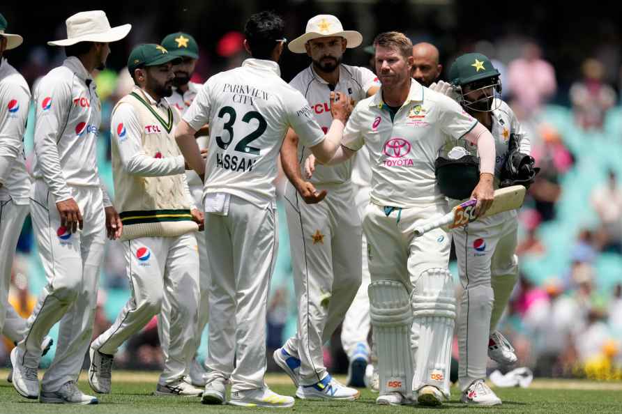 Australia's David Warner, third right, is congratulated by Pakistan...