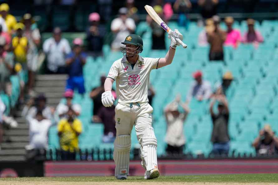 Australia's David Warner raises his bat after making 50 runs against...