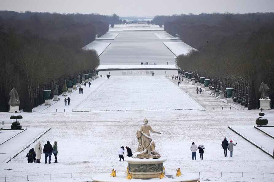 Tourists stroll in the gardens of the Chateau de Versailles