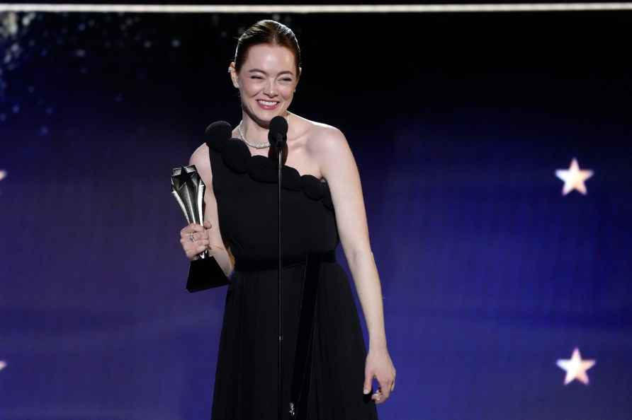 Emma Stone accepts the award for best actress for 