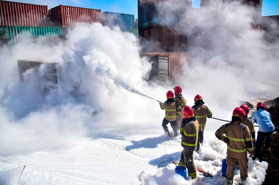 Navi Mumbai: Firefighters douse a fire which broke out in a container...