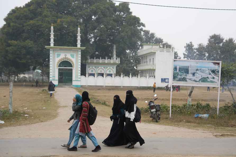 Ayodhya: Muslim women walk past the land allocated for the construction...