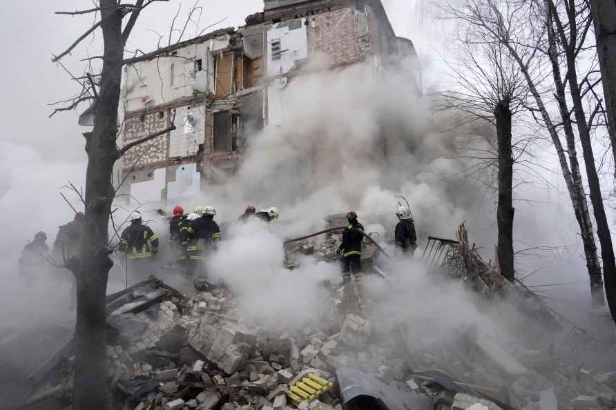 Rescuers work at the scene of a building damaged by Russian rocket...