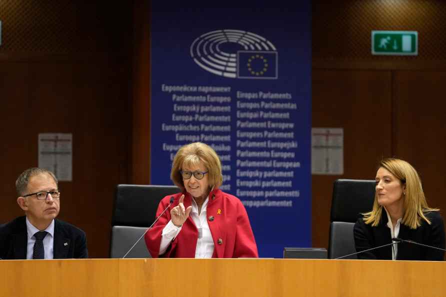 Irene Shashar, a survivor of the Warsaw ghetto, center, addresses...