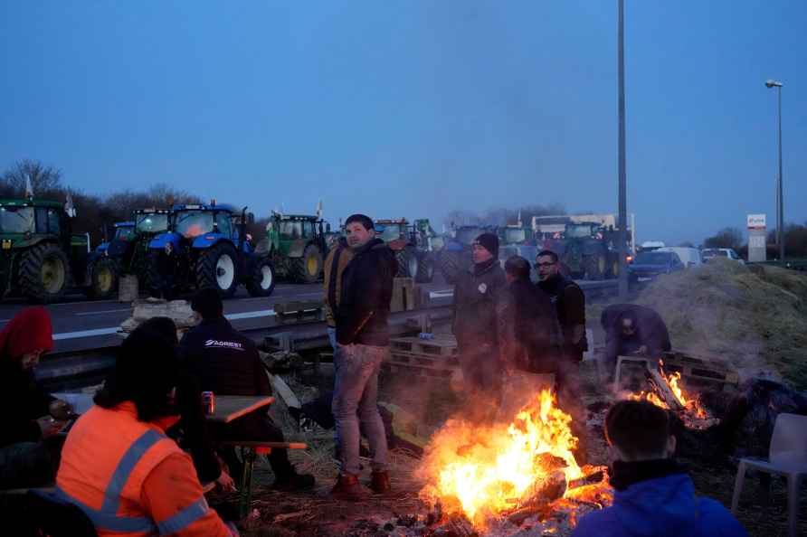 Farmers block a highway in Ourdy, south of Paris