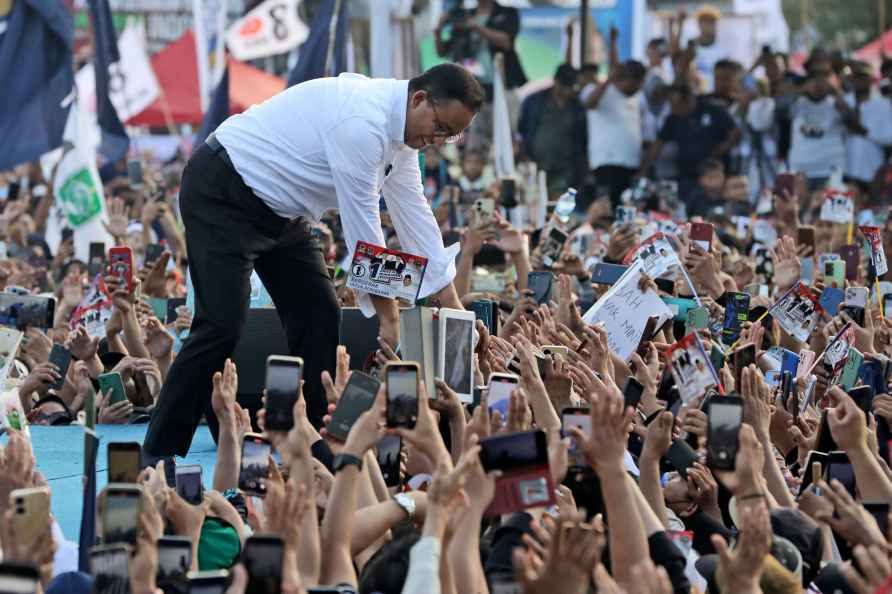 Indonesian presidential candidate Anies Baswedan greets supporters...