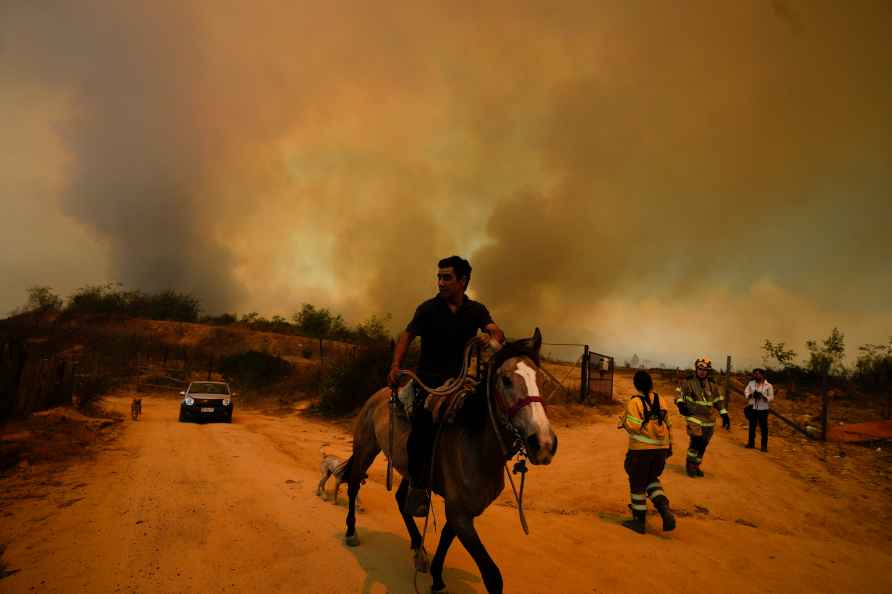 A resident flees an encroaching forest fire in Vina del Mar, Chile...