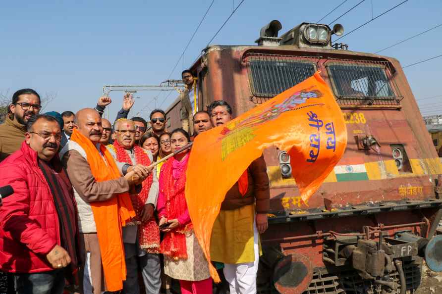 Jammu: BJP leaders wave a saffron flag during the departure of the...