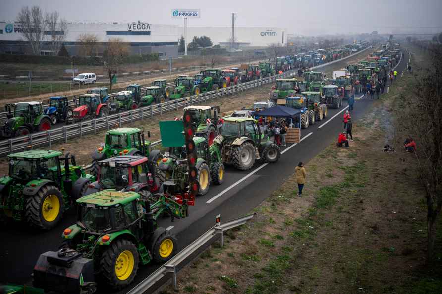 Parked tractors block a highway during a farmers' protest near Mollerussa...