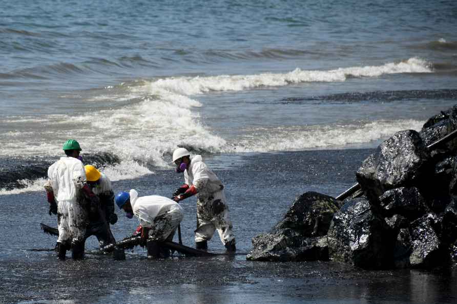 Workers clean oil spill in Tobago