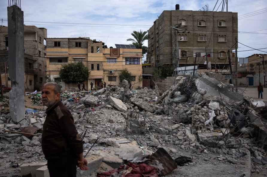 Neighbors inspect the rubble of the Hasouna family house, which ...