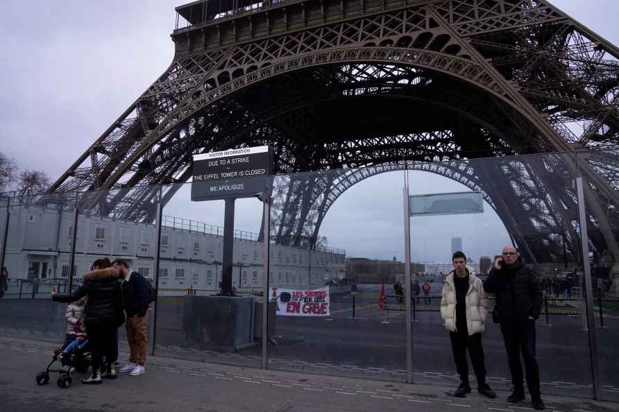 People stand outside the Eiffel Tower Monday, Feb. 19, 2024 in Paris...