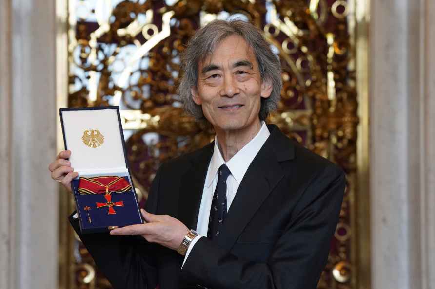 General Music Director and conductor Kent Nagano holds up the Federal...