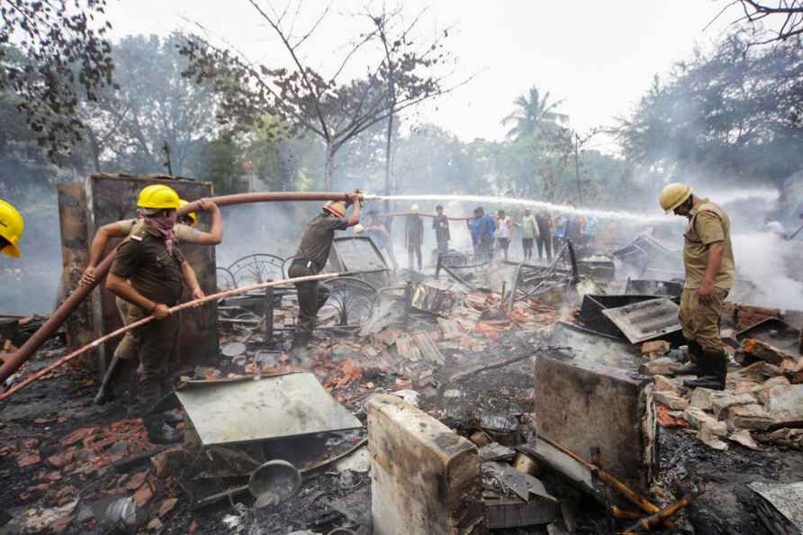 Kolkata: Fire fighters douse the a which broke out in a slum at ...