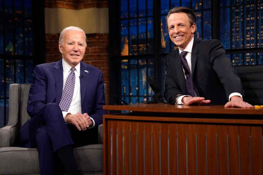 President Joe Biden talks with Seth Meyers during a taping of the...