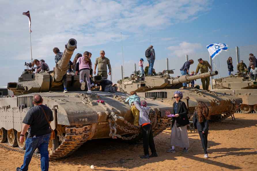 Israelis stand on tanks during an event for families of reservists...