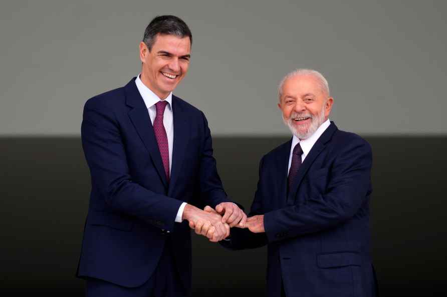 Spain's Prime Minister Pedro Sanchez, left, shakes hands with Brazil...