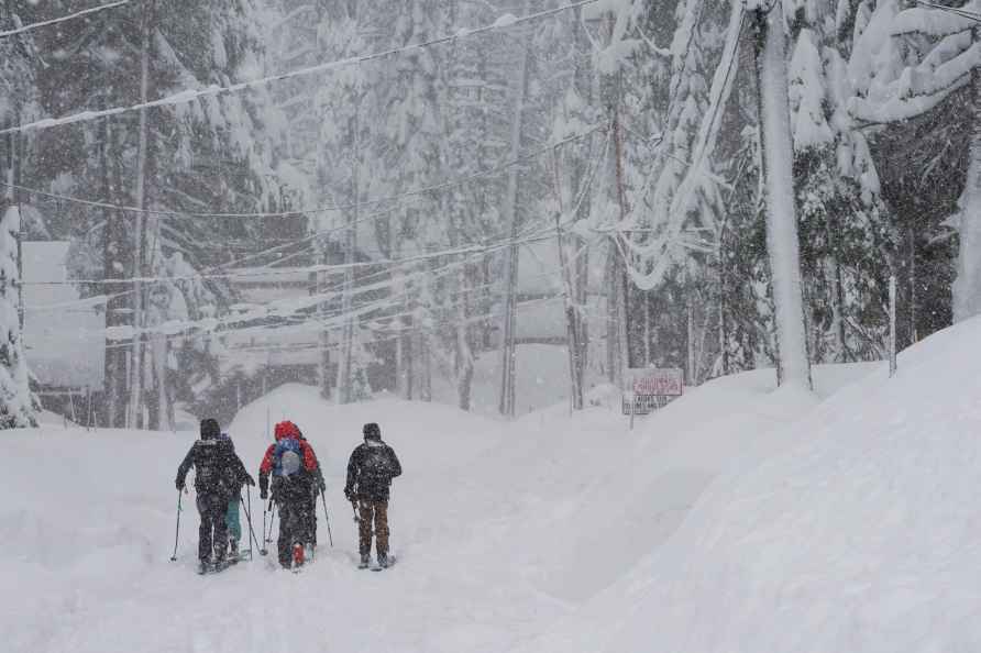 People ski on residential street