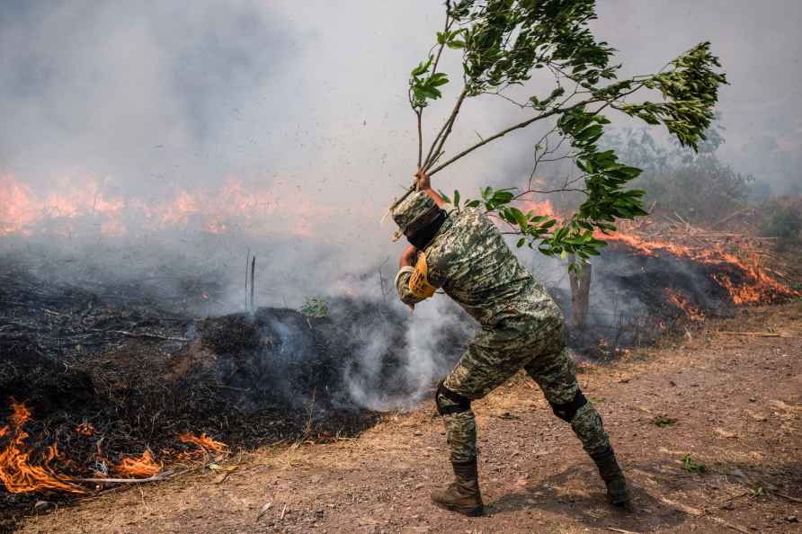 A soldier works to contain wildfires in Nogales, in the High Mountains...